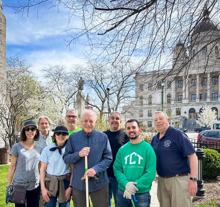 (Left) Friends of the Columbus Monument Corp. take part in an Earth Day cleanup in Syracuse, N.Y., on April 22, 2026, along with board members Nick Pirro (C), Anthony Ilacqua (3rd R), Dominick Ciciarelli (2nd R), and Ed McLaughlin (R). (Right) (L–R) Syracuse City Council member Marty Nave and Columbus Monument Corp. board members Nick Pirro, Anthony Ilacqua, and Richard Pietrafesa take part in a St. Patrick's Day parade in Syracuse on March 14, 2026. (Courtesy of Anthony Ilacqua)