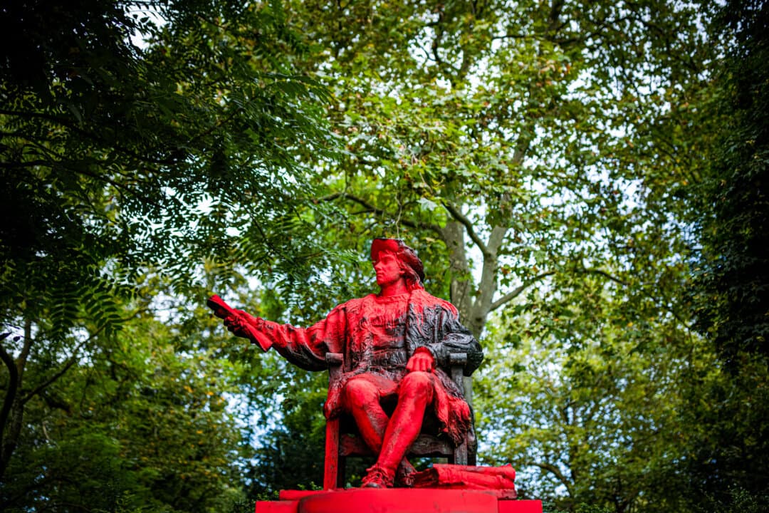 Red paint covers a statue of Christopher Columbus in the Belgravia district of London on Oct. 12, 2021. From being hailed as an explorer and hero, Columbus now faces the scorn of people who see him as an invader with a shameful legacy. (Rob Pinney/Getty Images)