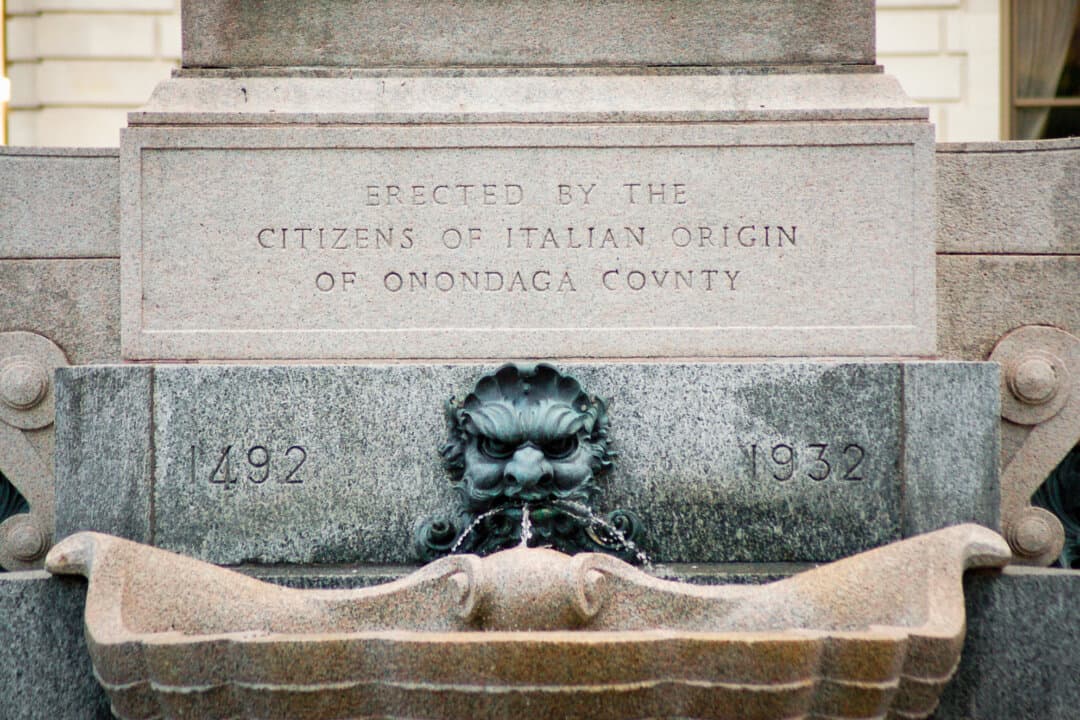 (Left) A statue of Christopher Columbus looks out over the city of Syracuse, N.Y., in this undated photo. (Right) An inscription at the base of the city's Columbus statue notes the contribution of Italian Americans. (Courtesy of Anthony Ilacqua)