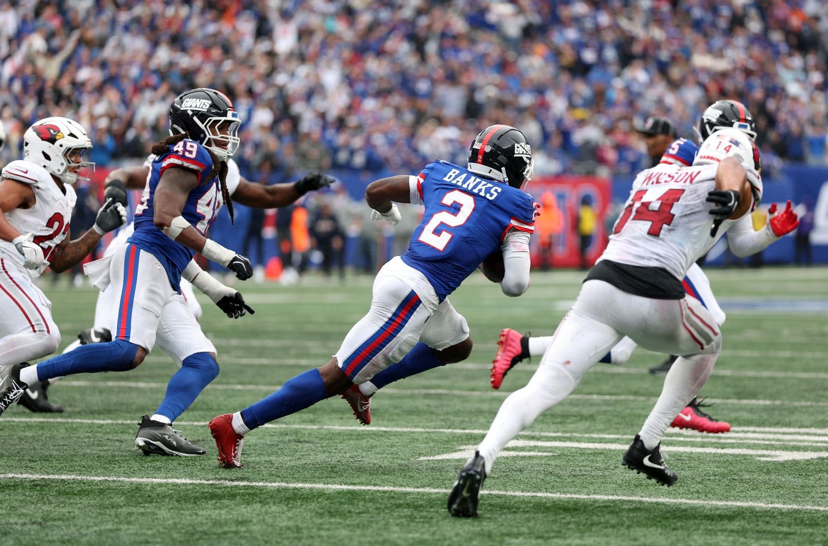 Deonte Banks #2 of the New York Giants carries the ball and returns it for a touchdown after an interception against the Arizona Cardinals during the fourth quarter at MetLife Stadium in East Rutherford, N.J., on Oct. 4, 2026. (Al Bello/Getty Images)