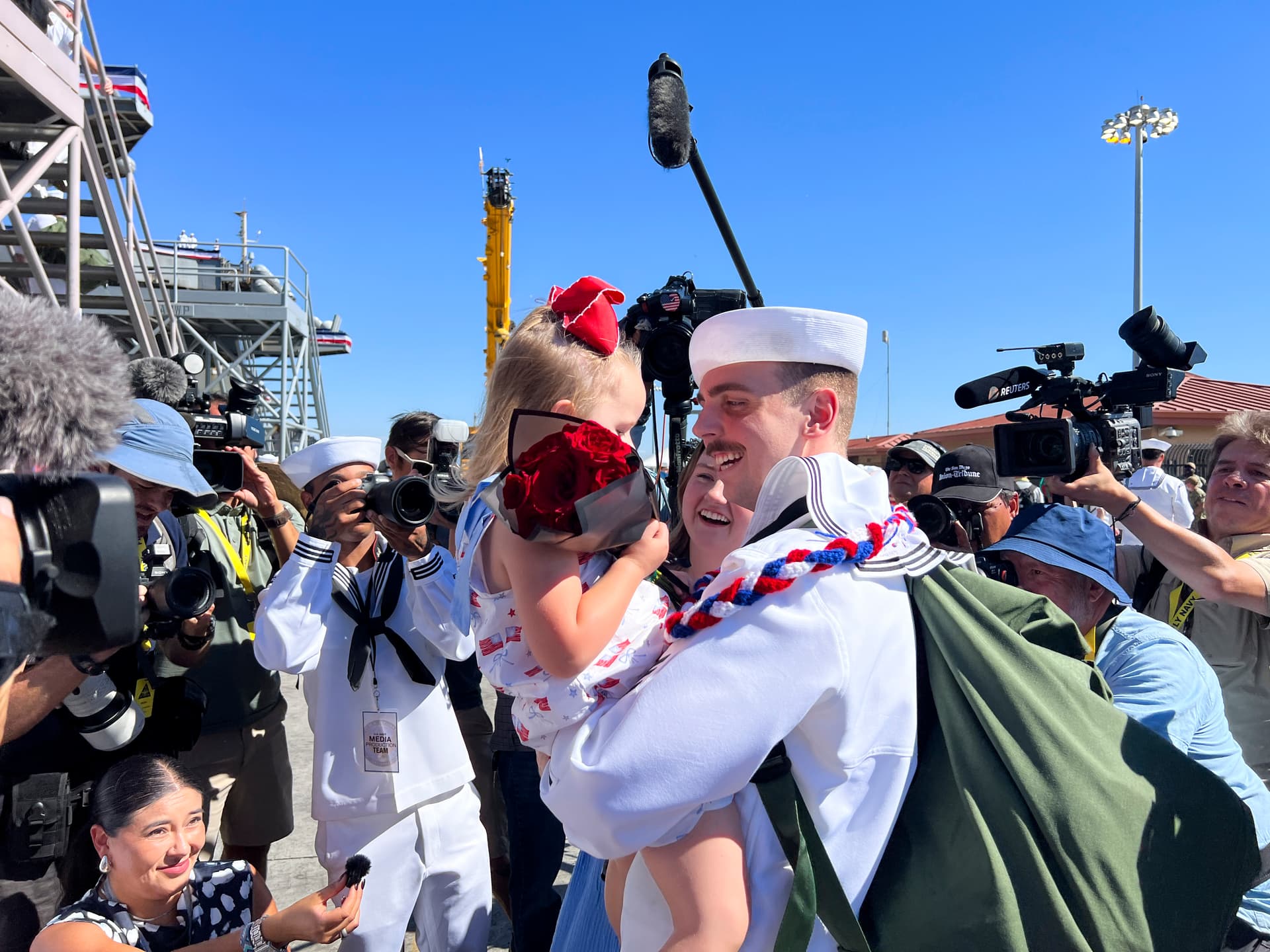 Sailors who served on the USS Abraham Lincoln reunite with families and friends as the aircraft carrier returns to its home port in San Diego on Oct. 8, 2026. (Brad Jones/The Epoch Times)