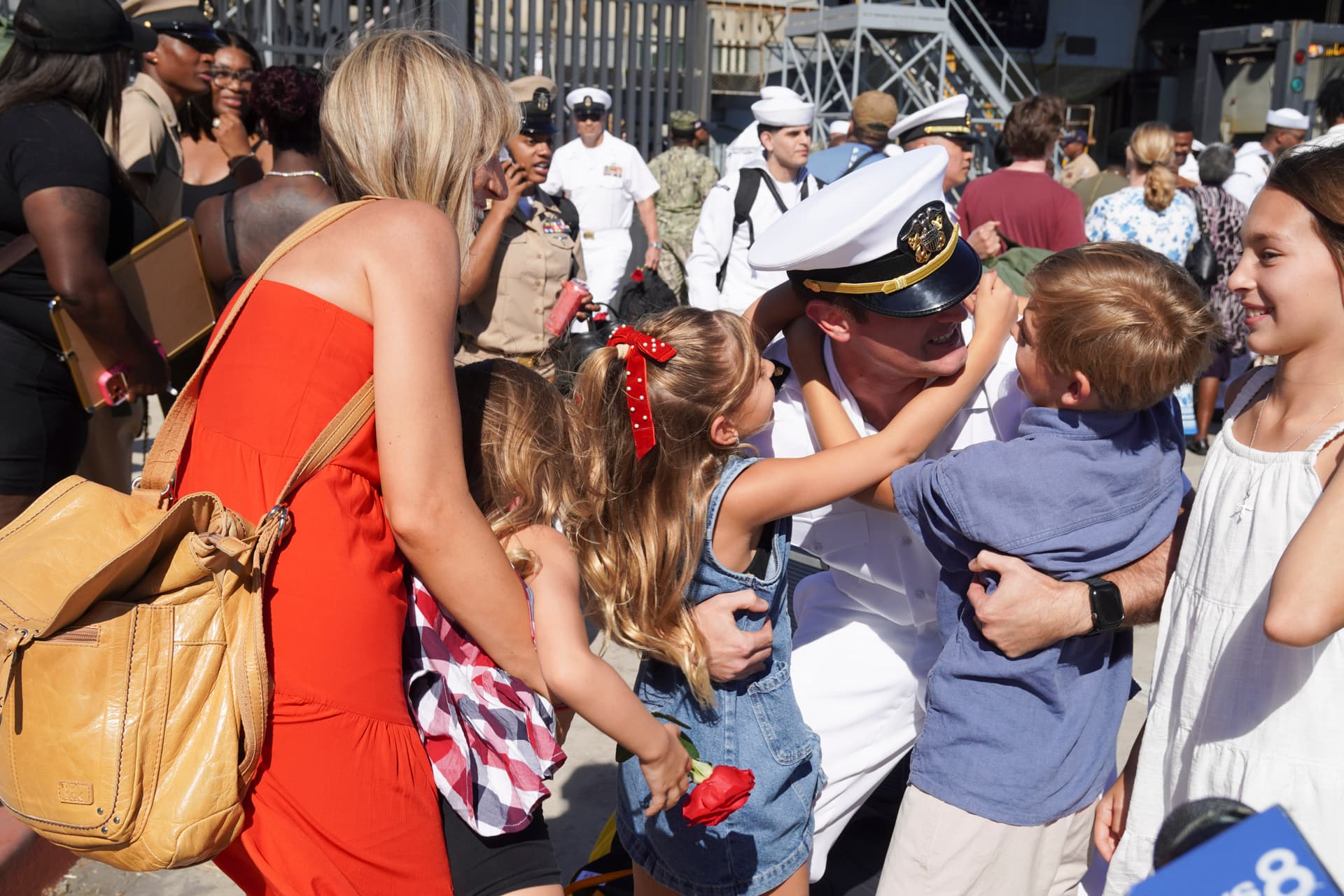 Sailors who served on the USS Abraham Lincoln reunite with families and friends as the aircraft carrier returns to its home port in San Diego on Oct. 8, 2026. (Brad Jones/The Epoch Times)