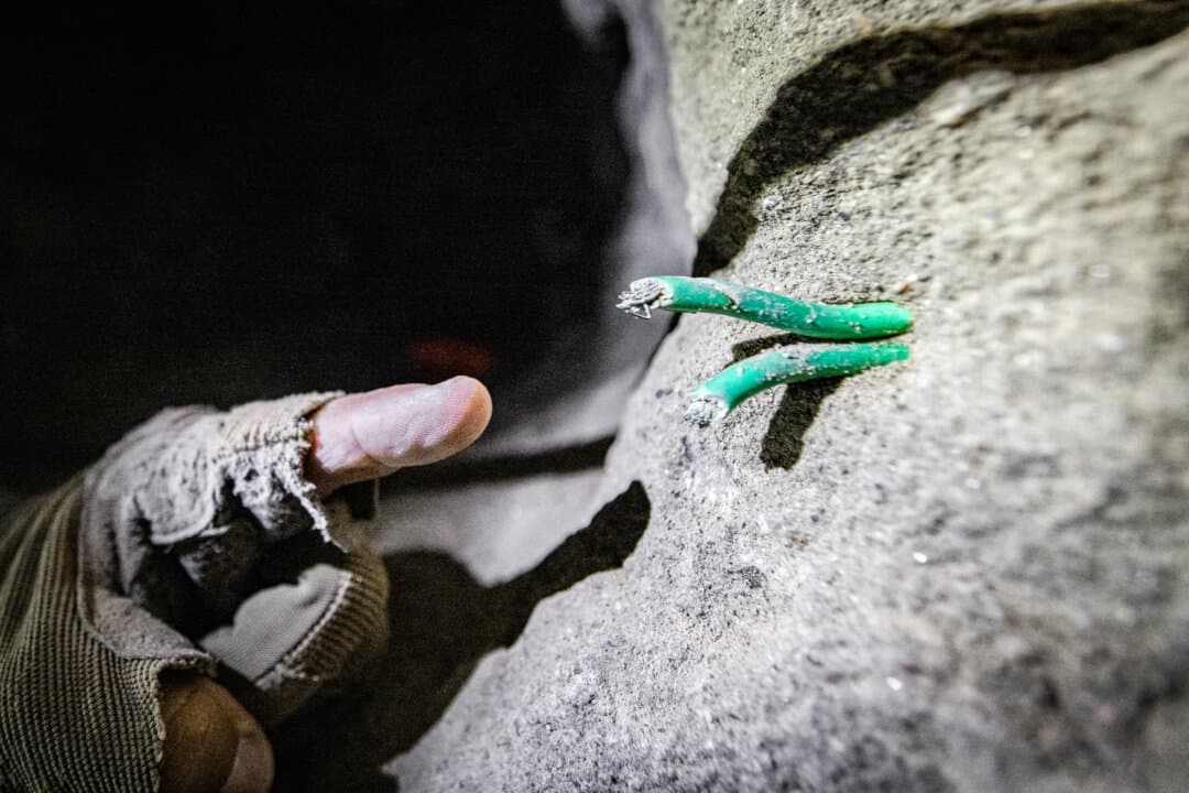 (Top) U.S. Border Patrol Agent Michael Sablan crawls through a Mexican drug cartel tunnel that once led to a warehouse outside of San Diego, on Sept. 17, 2026. (Bottom Left) Wiring used by Mexican drug cartels sits visible in an underground tunnel outside of San Diego, on Sept. 17, 2026. (Bottom Right) An air compressor sits in a tunnel used by drug cartels outside of San Diego on Sept. 17, 2026. (John Fredricks/The Epoch Times)