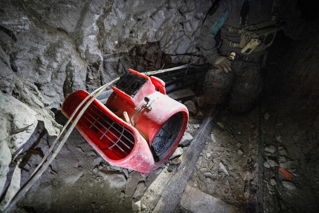 (Top) U.S. Border Patrol Agent Michael Sablan crawls through a Mexican drug cartel tunnel that once led to a warehouse outside of San Diego, on Sept. 17, 2026. (Bottom Left) Wiring used by Mexican drug cartels sits visible in an underground tunnel outside of San Diego, on Sept. 17, 2026. (Bottom Right) An air compressor sits in a tunnel used by drug cartels outside of San Diego on Sept. 17, 2026. (John Fredricks/The Epoch Times)