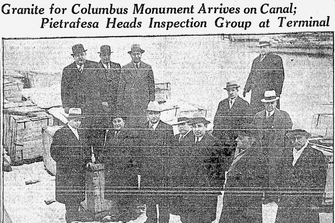 Thirteen men—including the father and grandfather of interviewees Nick Pirro and Anthony Ilacqua—stand on a barge in a canal at Brewerton, near Syracuse, N.Y., in this photo from a 1933 newspaper clipping. The men were welcoming the arrival of tons of pink granite from Italy that would form the pedestal and base of the city's Christopher Columbus statue. (Courtesy of Anthony Ilacqua)