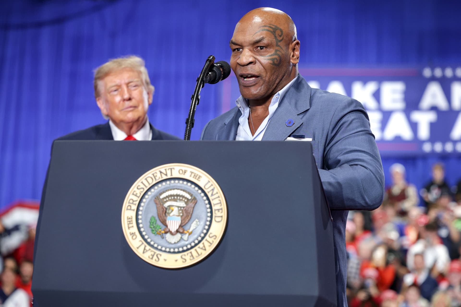 President Donald Trump listens as former professional boxer Mike Tyson (R) speaks on stage during an election rally at the Oncenter in Syracuse, N.Y., on Oct. 9, 2026. (Alex Wong/Getty Images)
