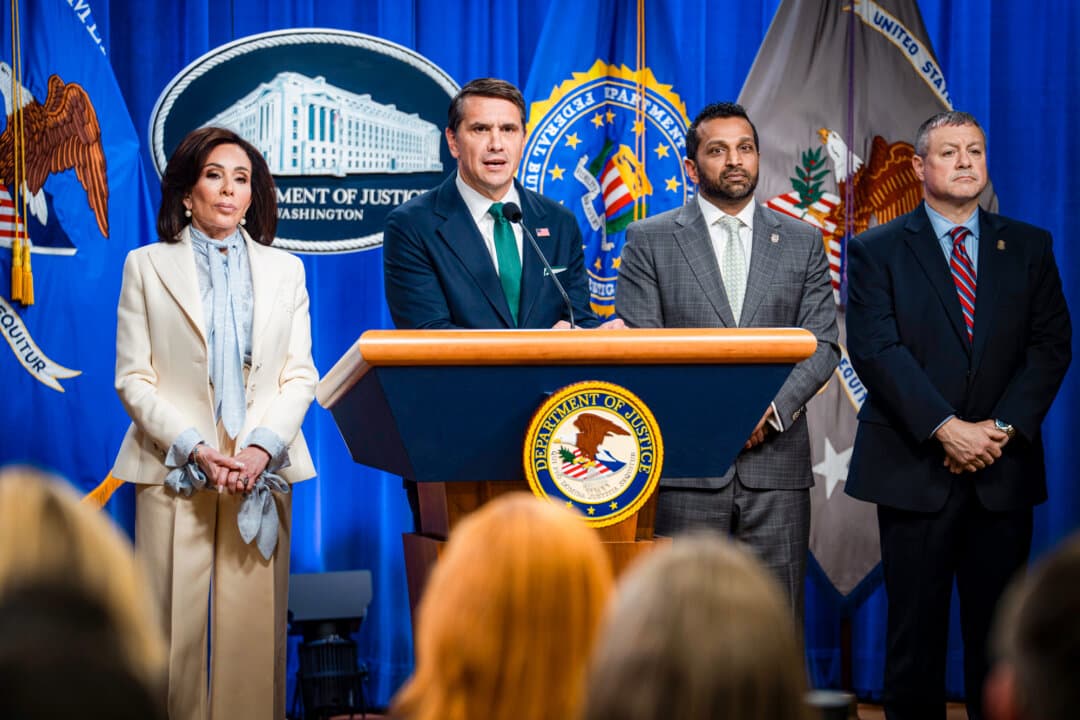 (L–R) U.S. Attorney Jeanine Pirro, then-acting Attorney General Todd Blanche, FBI Director Kash Patel, and Assistant Director in Charge of the FBI Washington Field Office Darren Cox speak during a news conference about the White House correspondents' dinner shooting, at the Justice Department in Washington on April 27, 2026. (Madalina Kilroy/The Epoch Times)