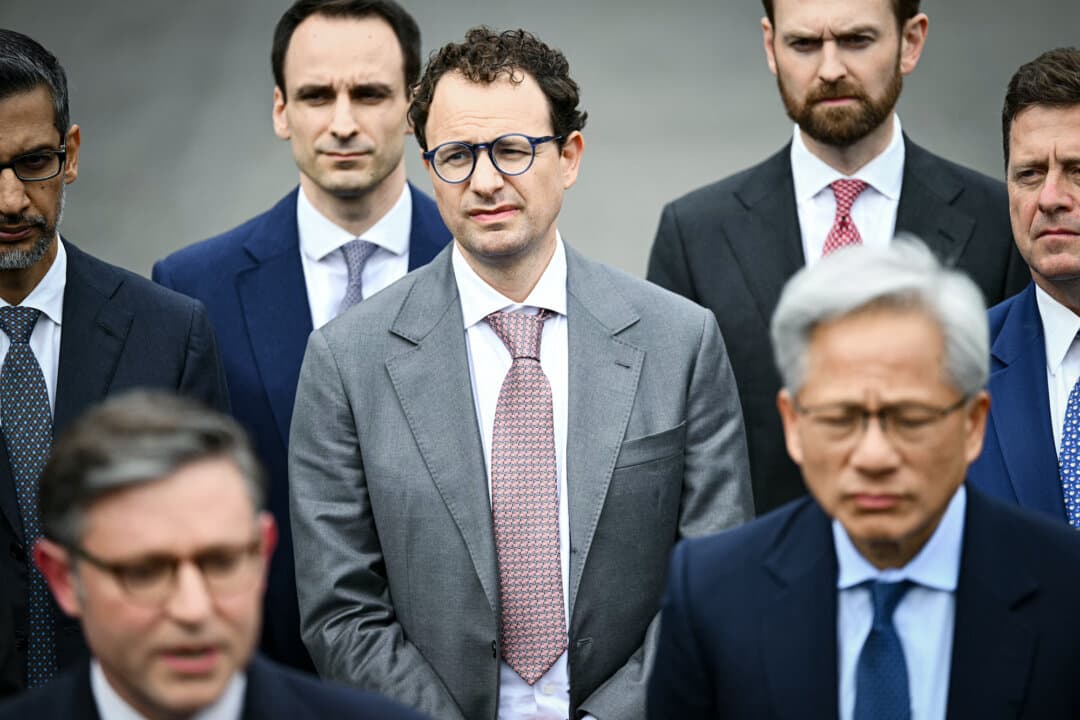 Dario Amodei (C), co-founder and CEO of Anthropic, looks on as House Speaker Mike Johnson (R-La.) talks to reporters after a meeting with technology executives about artificial intelligence, at the White House on Sept. 29, 2026. (Kent Nishimura/AFP via Getty Images)