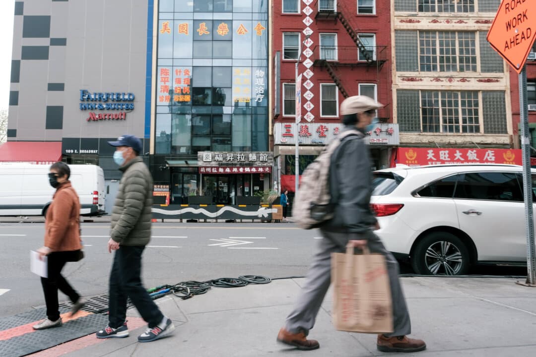 People walk by a building (2nd L) that was used as a secret police station in order to repress on behalf of the Chinese government dissidents living in the United States, in the Chinatown neighborhood of Lower Manhattan, New York City, on April 18, 2023. (Spencer Platt/Getty Images)