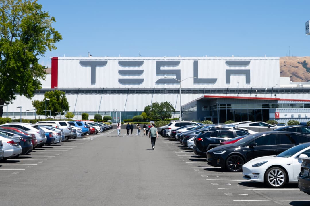 Electric and gas-powered vehicles are parked in a lot at the Tesla factory in Fremont, Calif., on July 26, 2025. (Gary Wang/The Epoch Times)