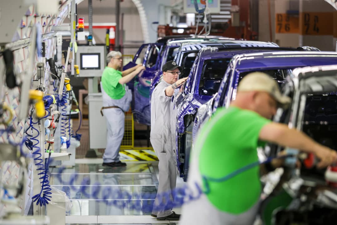 Volkswagen assembly workers perform final checks and corrections on electric cars in the paint shop at the Volkswagen electric car factory in Emden, Germany, on Feb. 24, 2026. (Focke Strangmann/Getty Images)