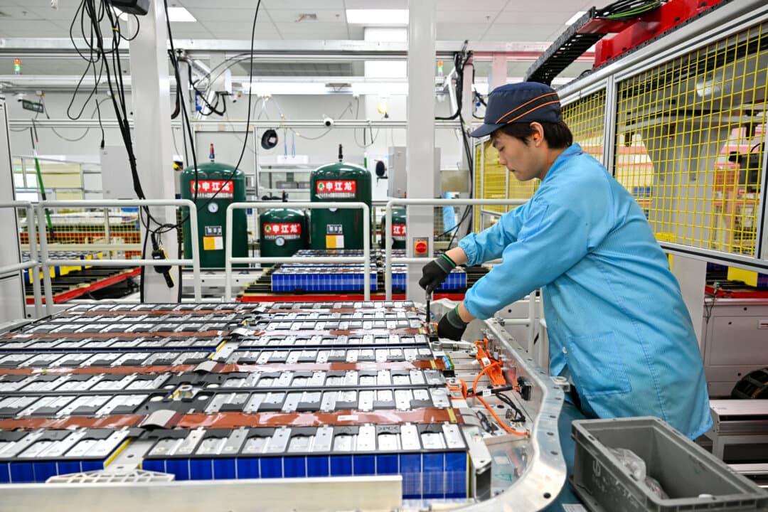 An employee works on batteries for electric vehicles at the Leap Energy factory, in Huzhou, Zhejiang Province, China, on April 26, 2026. (Adek Berry/AFP via Getty Images)