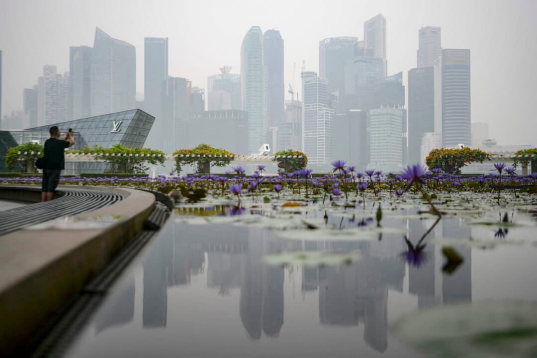 A reflection of the skyline is seen in Singapore on Oct. 15, 2026, as the country continues to be shrouded in haze caused by fires in Indonesia. (Feline Lim/AFP via Getty Images)