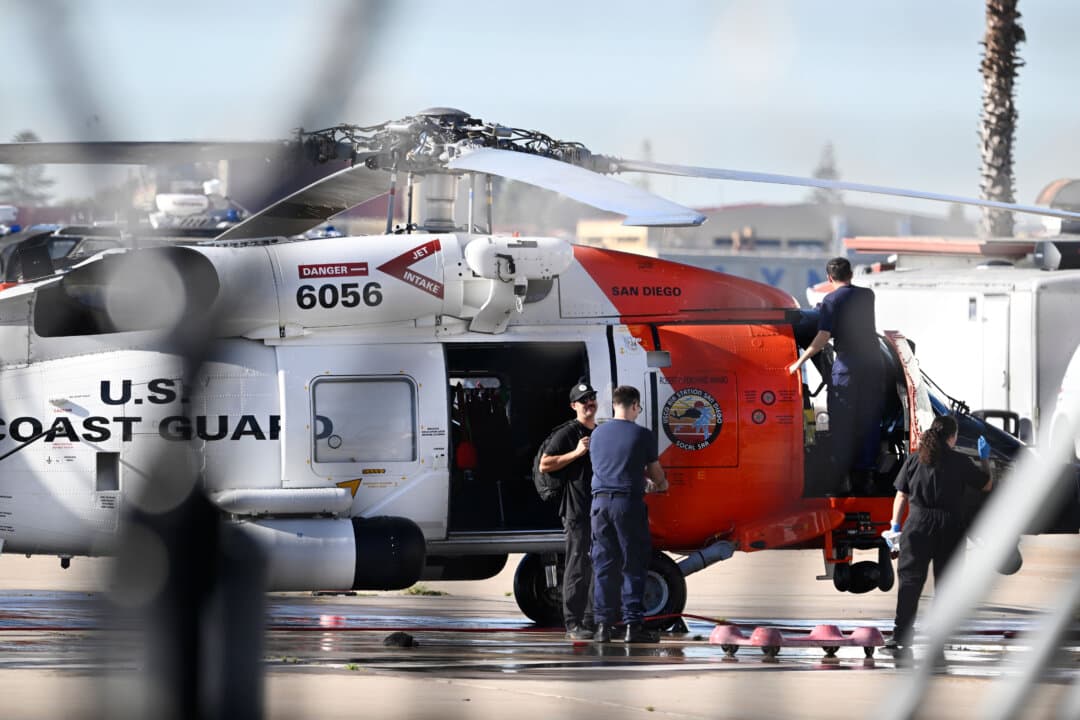 Crews work on a helicopter at the Coast Guard station in San Diego on Oct. 16, 2026. (Denis Poroy/AP)