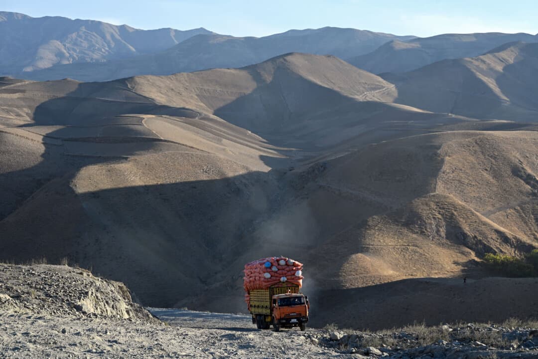 A fully loaded truck drives along a rugged mountain road in Argo district in Badakhshan Province, Afghanistan, on Oct. 16, 2026. (Omer Abrar/AFP via Getty Images)