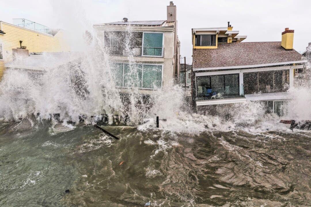 Pacific Ocean waves wash into damaged homes amid high surf generated by Tropical Storm Rachel in Long Beach, Calif., on Oct. 11, 2026. (Mario Tama/Getty Images)