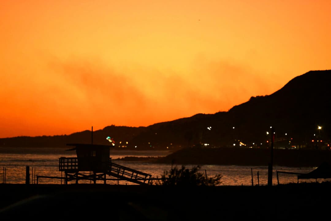 Smoke from the Bryson Fire rises over the Malibu Hills at sunset on Oct. 15, 2026, as the blaze prompts evacuation warnings and an order for the Encinal Canyon area ahead of Southern California’s first Santa Ana wind event of the season. (Patrick T. Fallon/AFP via Getty Images)