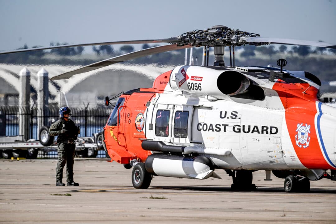 A U.S. Coast Guard member prepares for takeoff at Coast Guard Station San Diego on Oct. 16, 2026. (AP Photo/Denis Poroy)