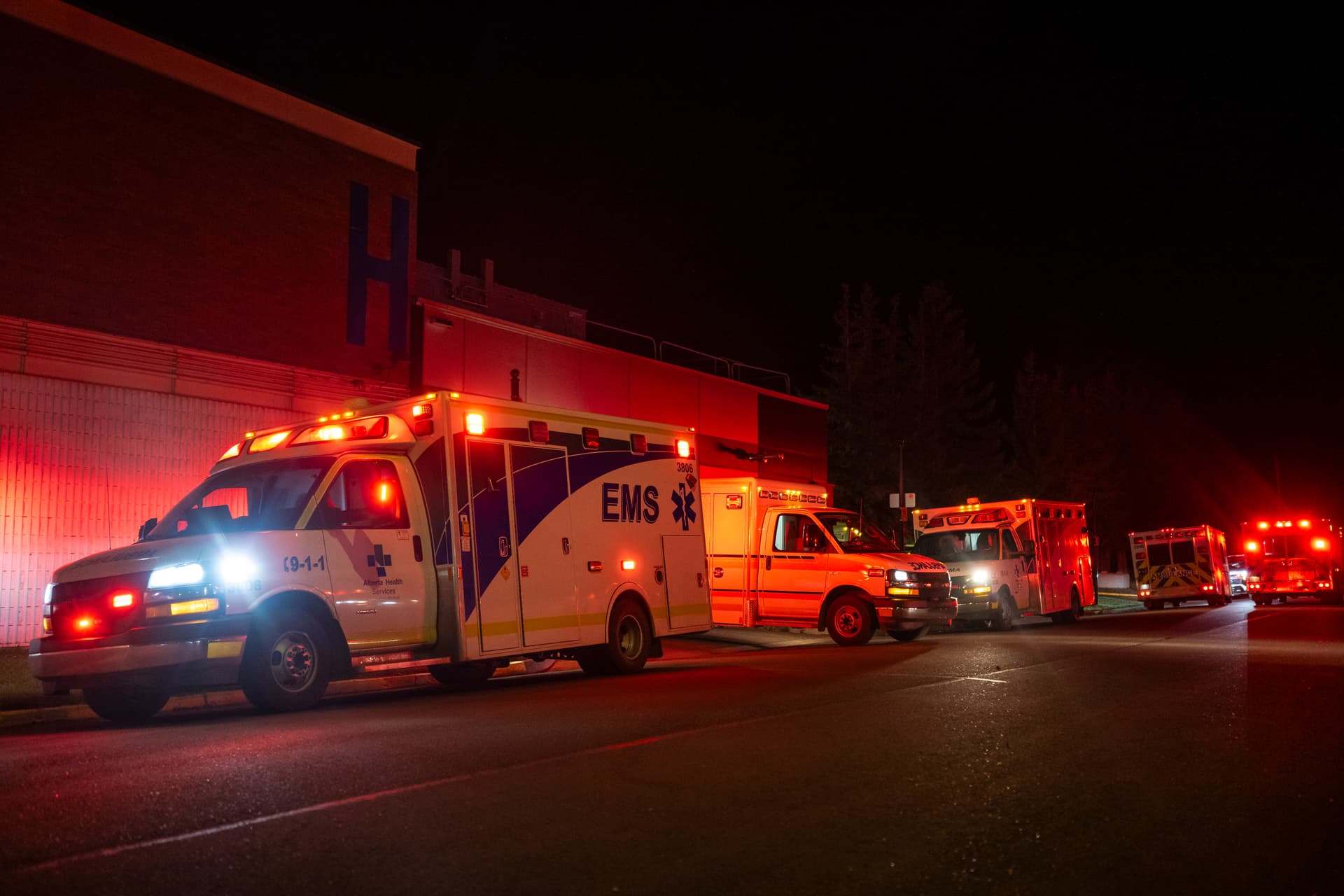 Emergency crews and military personnel at the Wainwright Health Centre as injured military members are treated after a fire at CFB Wainwright, outside of Wainwright, Alta., on Oct. 17, 2026. (The Canadian Press/John Ulan)