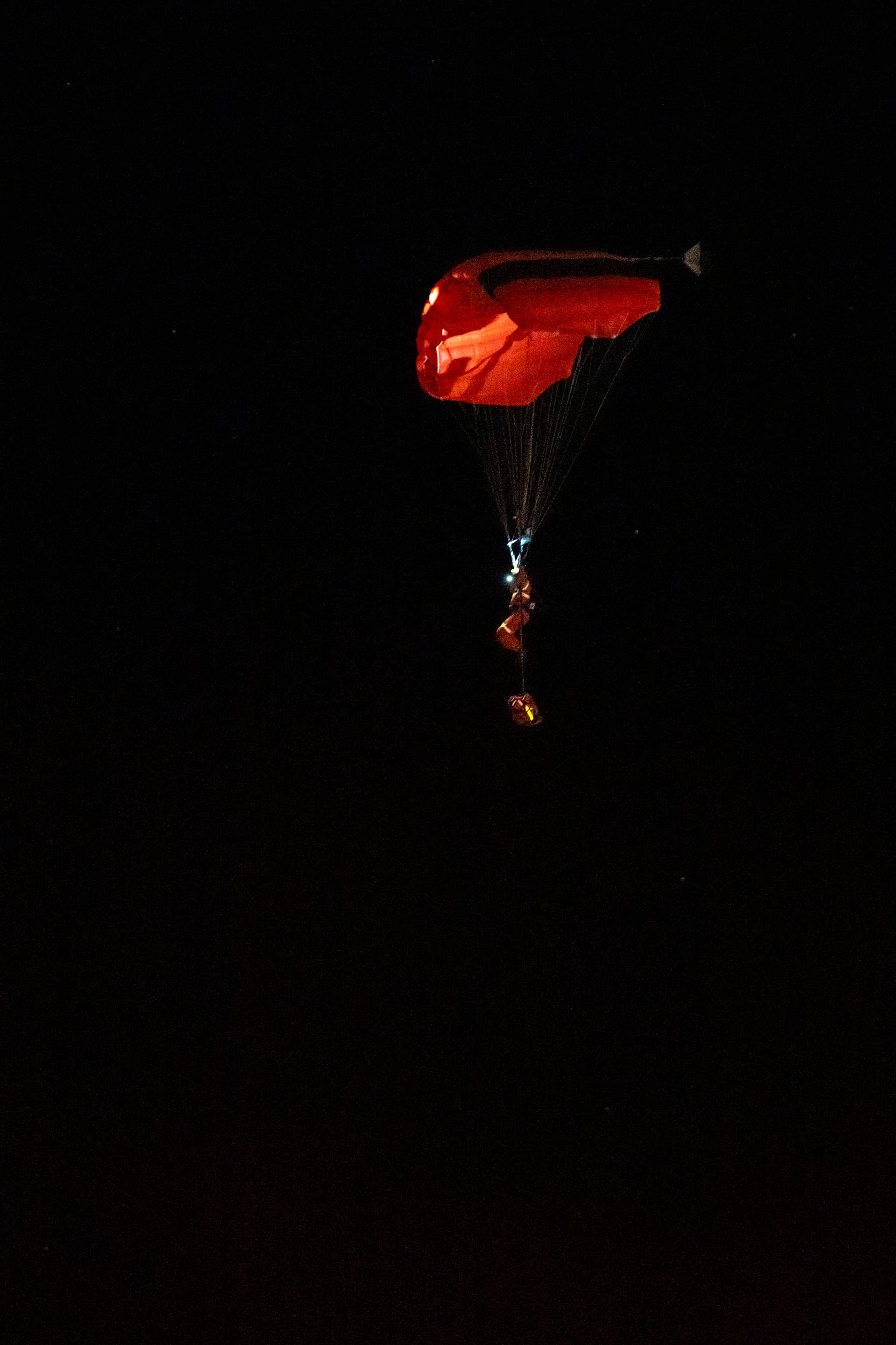 A person parachutes near the Wainwright Health Centre as injured military members are treated after a fire at CFB Wainwright, outside of Wainwright, Alta., on Oct. 17, 2026. (The Canadian Press/John Ulan)