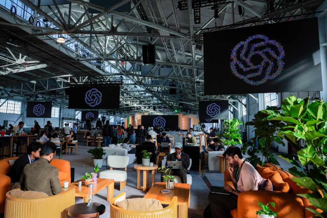 Attendees gather for an OpenAI developers' conference in San Francisco on Sept. 29, 2026. In August 2026, the Justice Department reached a $3.2 million settlement with OpenAI and an OpenAI subsidiary over alleged Program Electronic Review Management violations. (Heather Diehl/Getty Images)