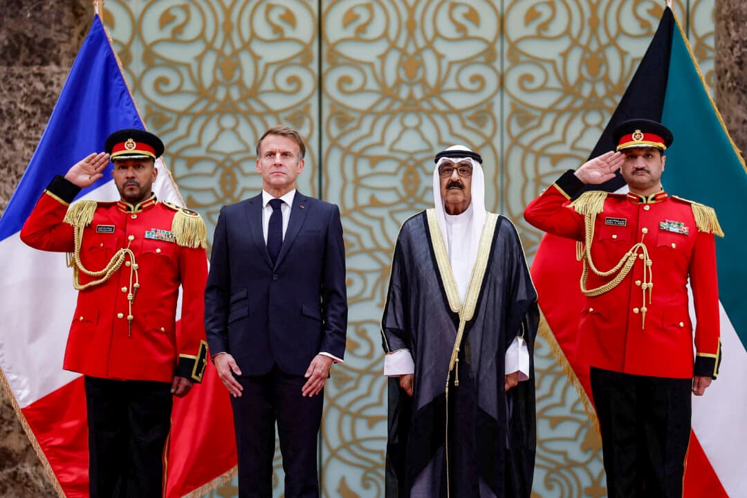The Emir of Kuwait Sheikh Mishal Al-Ahmad Al-Jaber Al-Sabah (2nd-R) poses with French President Emmanuel Macron during a welcoming ceremony upon Macron's arrival at Kuwait International Airport in Kuwait, on Oct. 19, 2026. (Benoit Tessier/POOL/AFP via Getty Images)