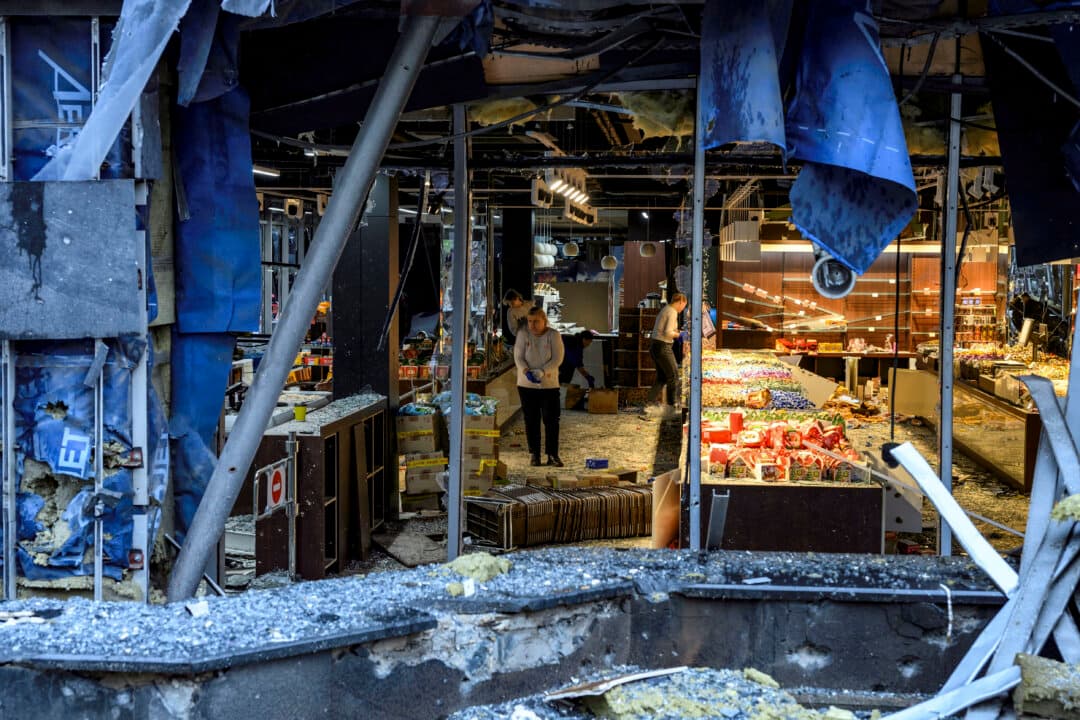 People clear debris in a damaged shopping mall following an air strike on Kyiv, on Oct. 19, 2026, amid the war with Russia. (Vladyslav Musiienko/AFP via Getty Images)
