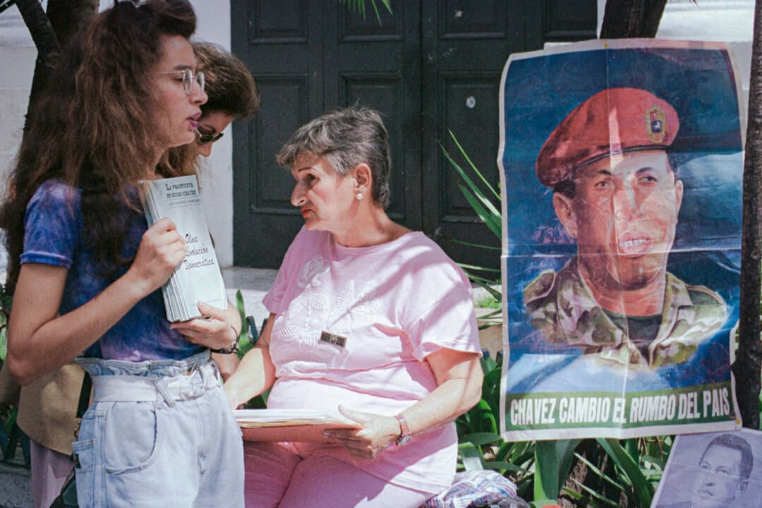 A supporter of the Fifth Republic Movement, the left-wing political party founded by Hugo Chavez, distributes literature in Caracas, Venezuela, ahead of the 1998 Venezuelan presidential campaign that brought Chavez to power. (Bertrand Parres/AFP via Getty Images)