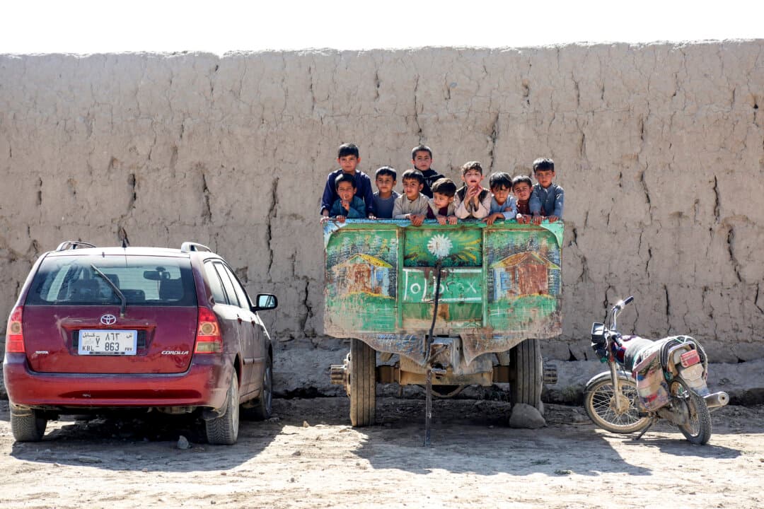 Afghan children look out from a parked tractor in the Qarabagh district of Afghanistan's Ghazni province on Oct. 20, 2026. (Mohammad Faisal Naweed/AFP via Getty Images)