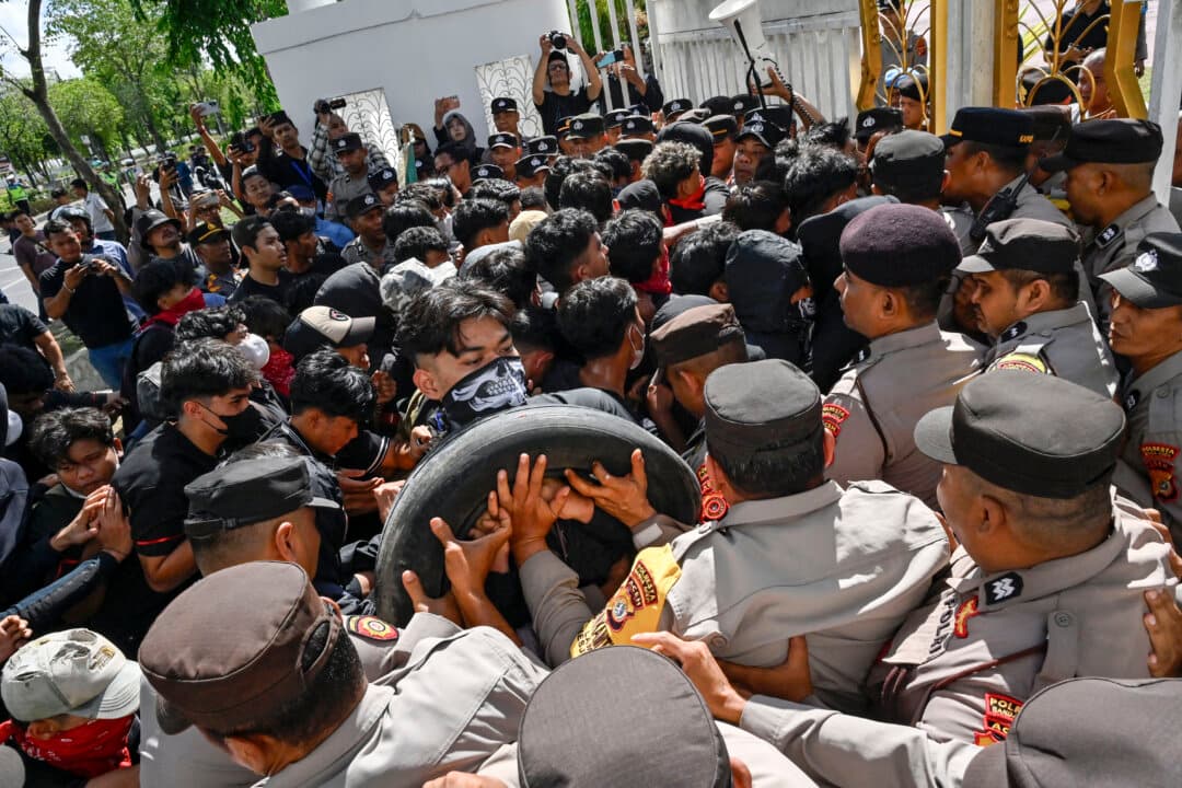 University students protest outside the Aceh governor’s office in Banda Aceh, Indonesia, on Oct. 20, 2026, demanding faster post-flood reconstruction, climate action, and measures to address the rising cost of living. (Chaideer Mahyuddin/AFP via Getty Images)