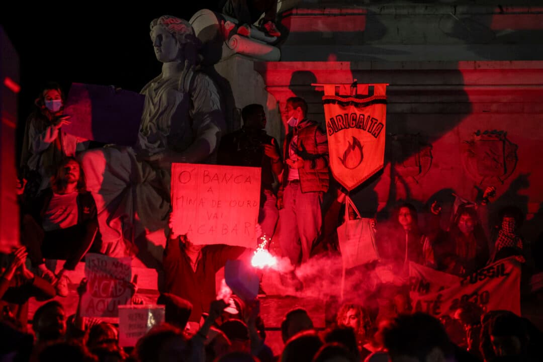People gather at Rossio Square in Lisbon, Portugal, on Oct. 20, 2026, to protest housing shortages, soaring rents, and low wages. Thousands demonstrated across the country after police dismantled housing protest camps and arrested 55 people. (Patricia de Melo Moreira/AFP via Getty Images)
