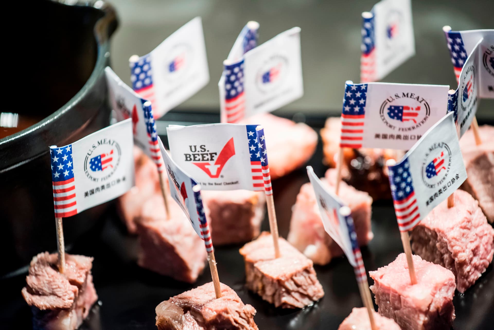 U.S. flags and branding are seen on cut U.S. beef samples during a promotional event in Beijing on June 30, 2017. (Fred Dufour/AFP via Getty Images)