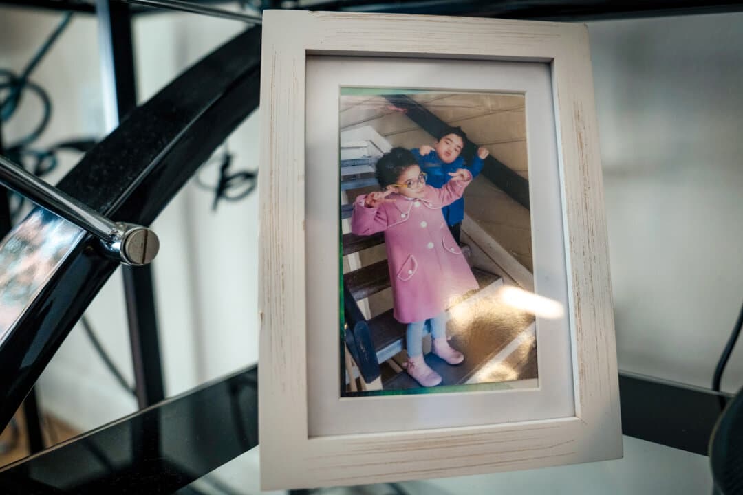 (Top) A photo of Mihrigul Tursun (2nd R) with her mother and children is displayed at the home of Mihrigul Tursun in Arlington, Va., on May 30, 2026. (Bottom Left) Mihrigul Tursun views a photo of herself with her mother in Arlington, Va., on May 30, 2026. The photo marked the last time she would see her mother, she said. (Bottom Right) A photo of Mihrigul Tursun's children is displayed at the home of Mihrigul Tursun in Arlington, Va., on May 30, 2026. (Madalina Kilroy/The Epoch Times)