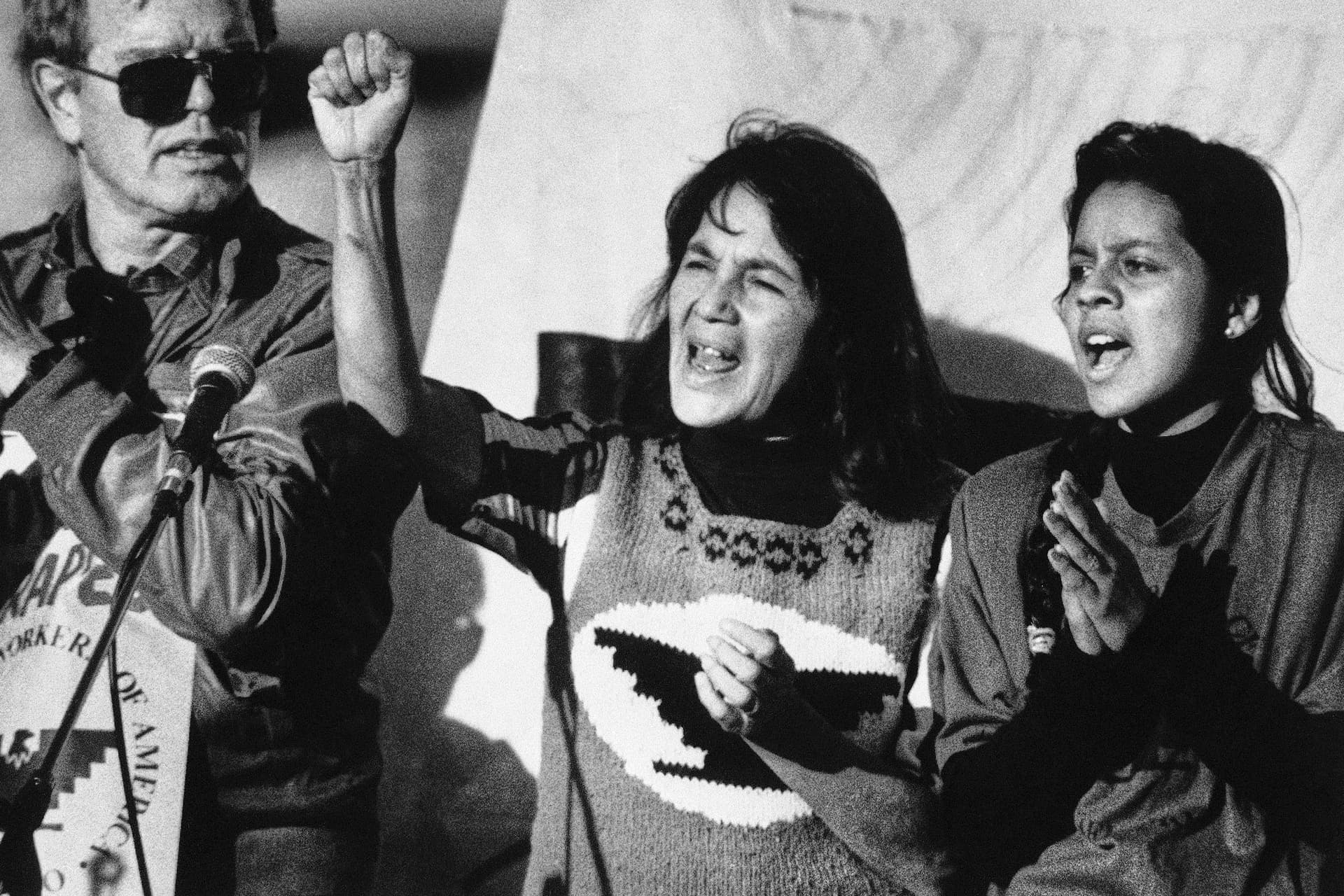 United Farm Workers leader Dolores Huerta, center, leads a rally in San Francisco's Mission District on Nov. 19, 1988, along with Howard Wallace, president of the San Francisco chapter of the UFW, left, and Maria Elena Chavez, 16, the daughter of Cesar Chavez, right, as part of a national boycott of what the UFW said is the dangerous use of pesticides on table grapes. (AP Photo/Court Mast, File)