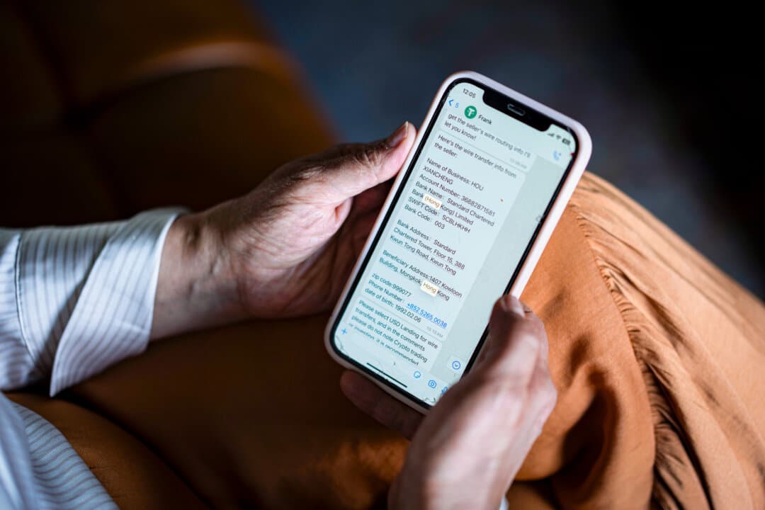 An online romance scam victim holds her phone in Washington, on May 27, 2026. (Madalina Kilroy/The Epoch Times)